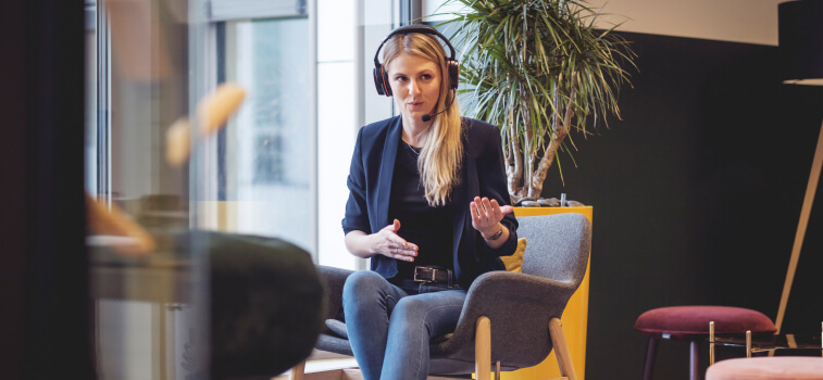 Focused woman speaking English while using the Pronounce headset