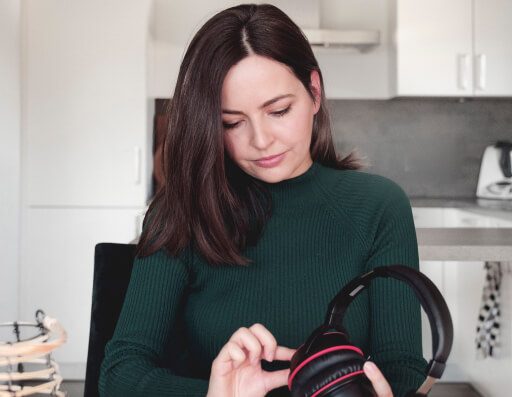 Woman turning on the Pronounce headset